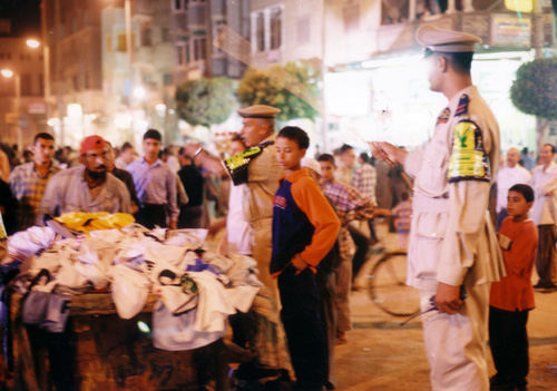 policemen removing vendors' stands at the mulid of as-Sayyid al-Badawi in Tanta, 2004. Photo (c) Samuli Schielke.